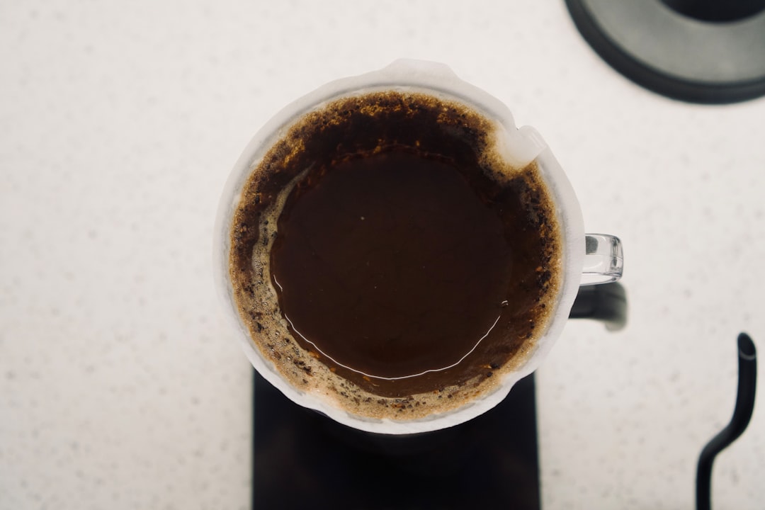 a-cup-of-coffee-sitting-on-top-of-a-counter-scflmlndqhs